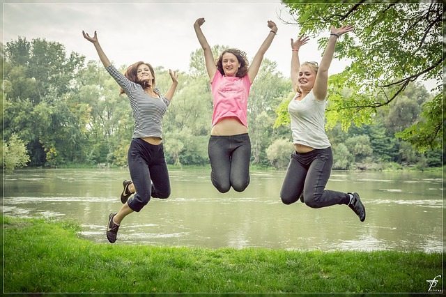 women jumping happy